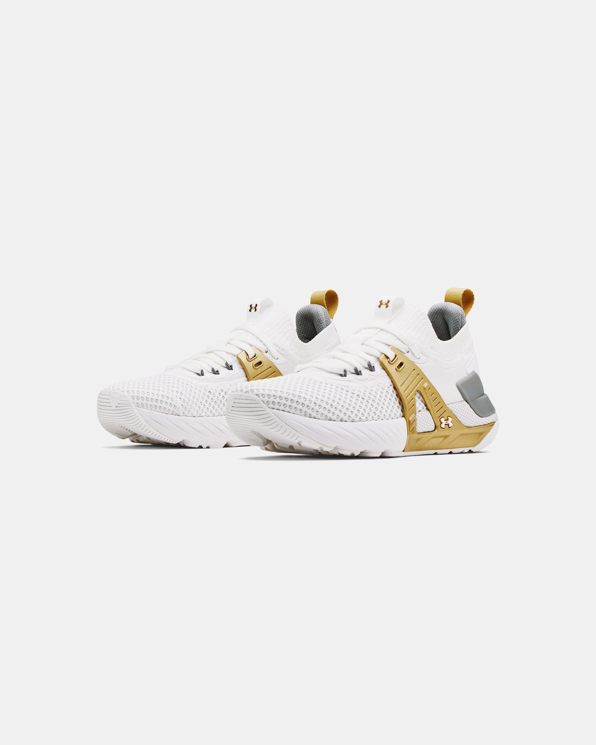 Gold and white top under armour shoes